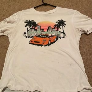 White medium t-shirt with graphic designs.